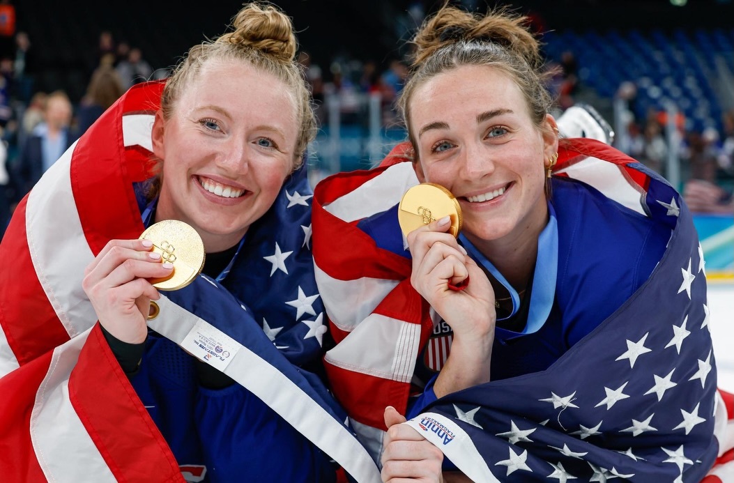 Team USA's Taylor Heise and Grace Zumwinkle with their gold medals at the Milano Cortina 2026 Winter Olympics.