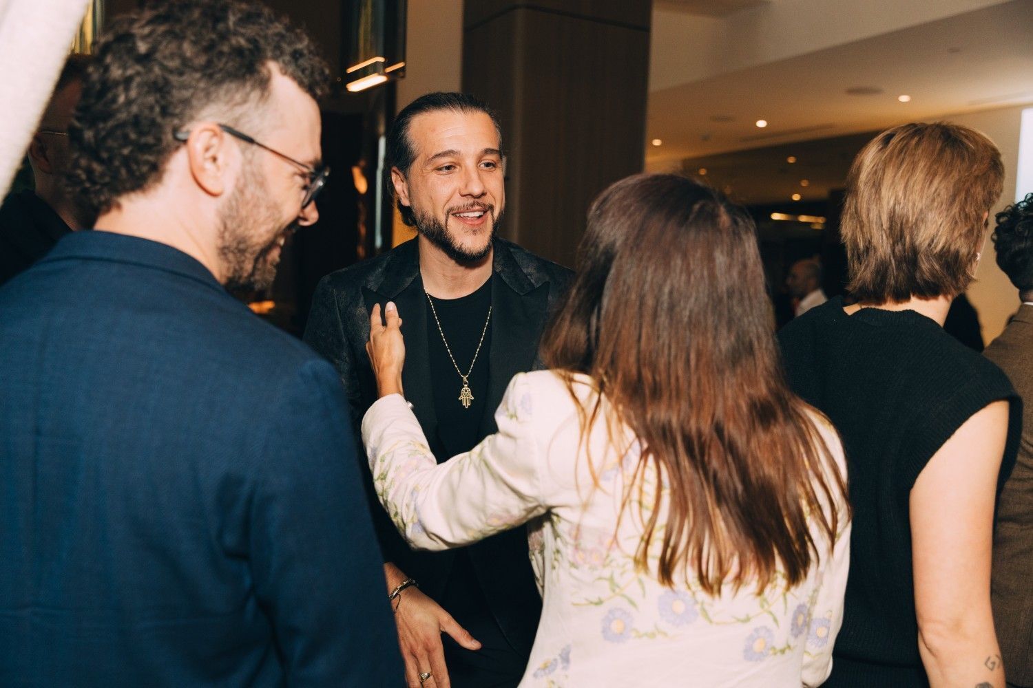 Karim Leduc socializing with guests at the Rebrand Launch Event.