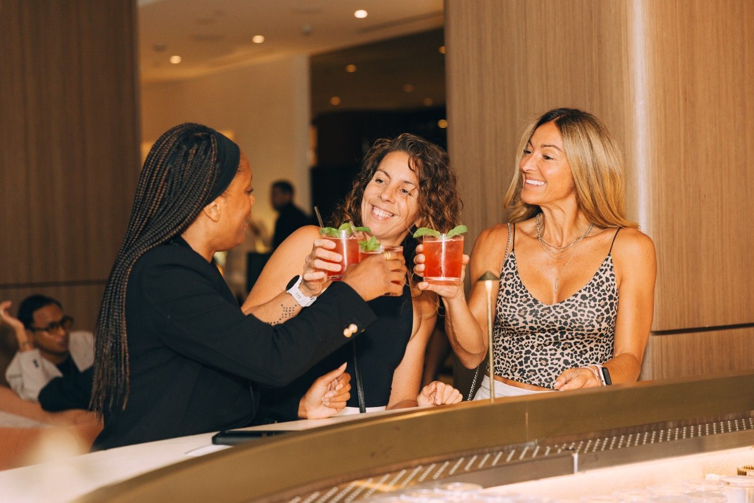 Image of guests chatting at launch event while drinking the signature cocktail.